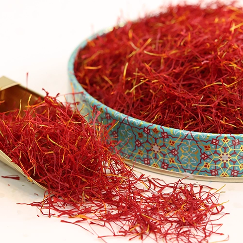 Poushal Saffron is placed in a container next to a decorative object.